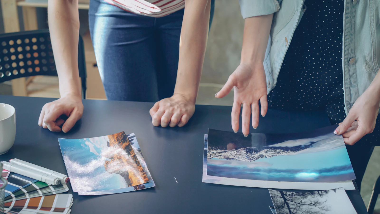 People are looking at photos on a table