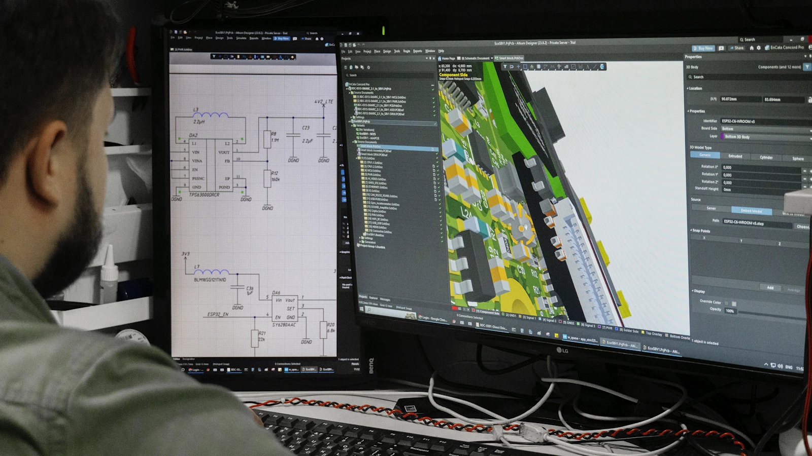 Man looking at circuit board design on computer screen